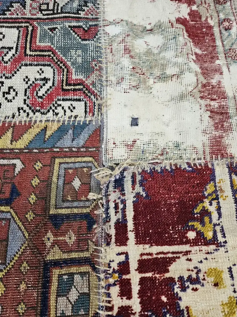 Close detail of an antique patchwork rug's pattern and pile