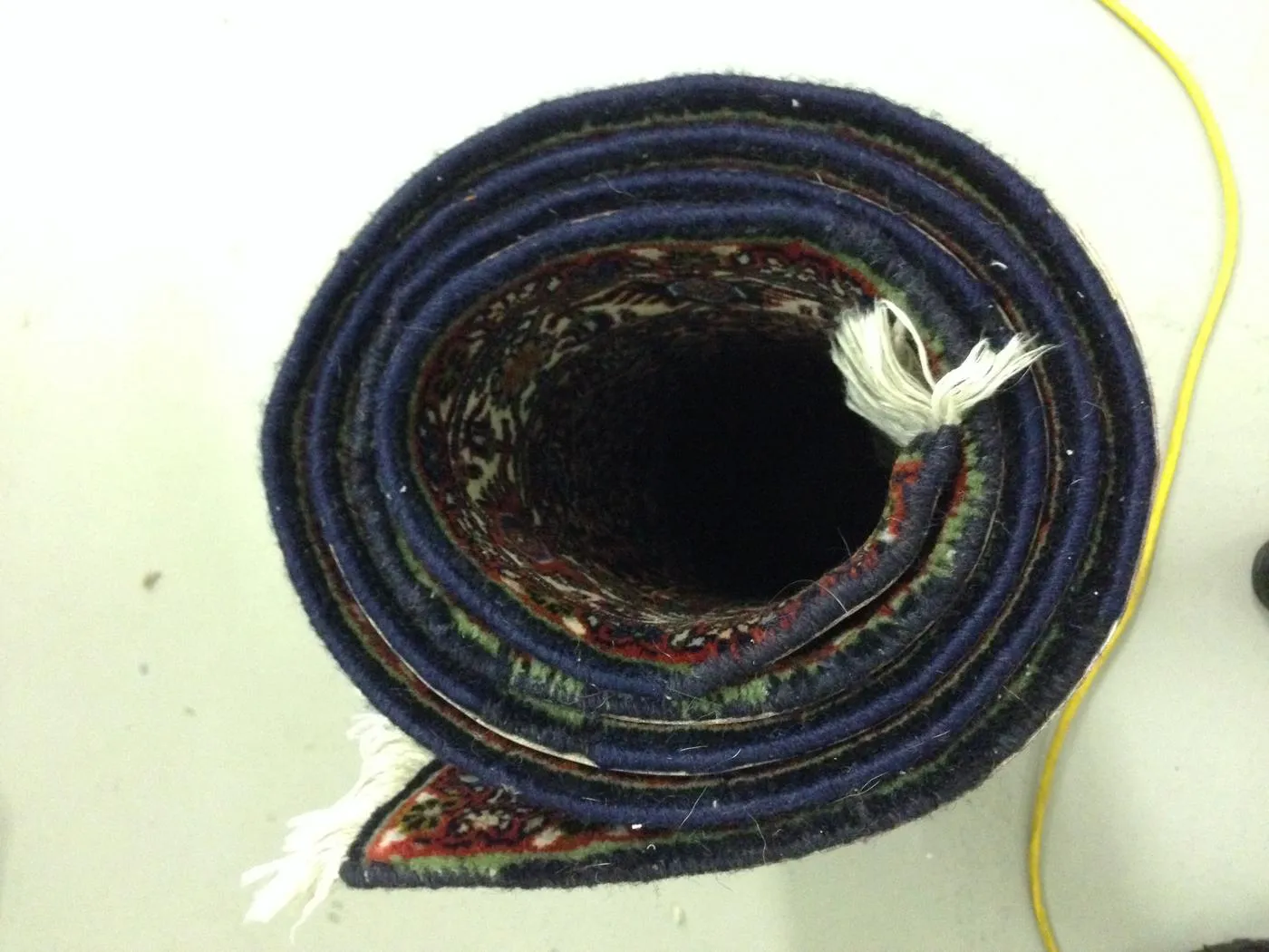 The same rug's side edge rewrapped and secured after repair