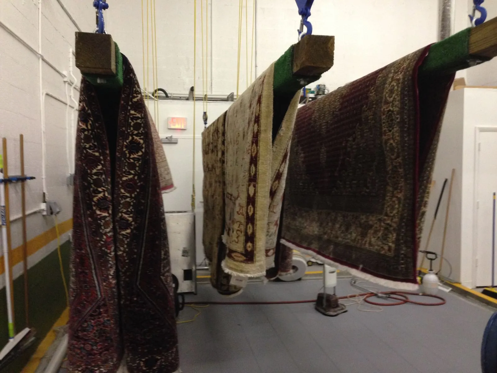 Washed rugs hanging to dry in the plant's controlled drying room